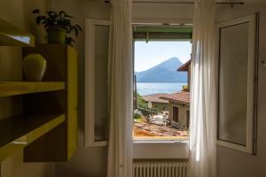 a window in a room with a view of the ocean at La Dolse Ca' - Lago di Garda in Brenzone sul Garda