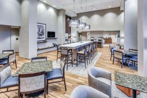 a dining room with a long table and chairs at Hampton Inn & Suites Kittery in Kittery