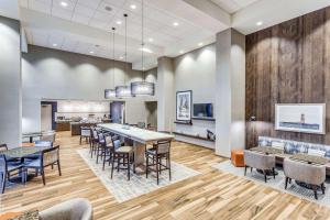 a dining area with tables and chairs in a lobby at Hampton Inn & Suites Kittery in Kittery