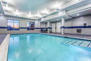 a swimming pool with blue water in a building at Hampton Inn & Suites Kittery in Kittery