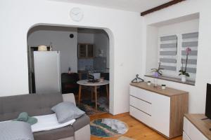 a living room with a couch and a kitchen at Ema Apartman in Livno