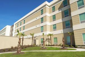 a building with palm trees in front of it at Home2 Suites By Hilton San Antonio At The Rim, Tx in San Antonio