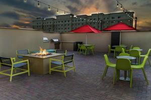 a patio with tables and chairs and a fire pit at Home2 Suites By Hilton San Antonio At The Rim, Tx in San Antonio
