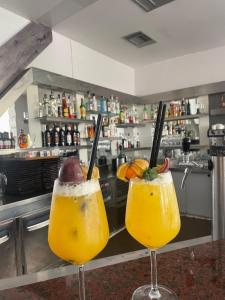 two cocktails sitting on a counter in a kitchen at Sanremo Hotel Restorant in Durrës