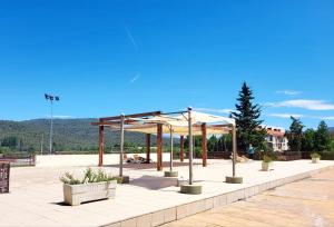 a pavilion with tables and umbrellas on a patio at CAL MA Ponts in Ponst