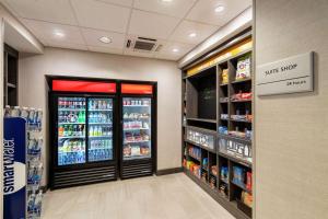 a store aisle with a soda cooler in a store at Hampton Inn & Suites Snellville Atlanta Ne in Snellville