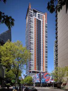 a tall building with a mural on the side of it at The Sound Hotel Seattle Belltown, Tapestry Collection in Seattle