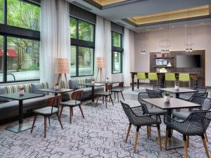 a restaurant with tables and chairs and windows at Hampton Inn & Suites Atlanta Decatur/Emory in Decatur