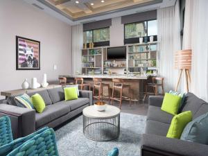 a living room with two couches and a bar at Hampton Inn & Suites Atlanta Decatur/Emory in Decatur