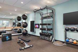 a gym with exercise equipment and a flat screen tv at Tru Lawrenceville Atlanta I85 Sugarloaf in Lawrenceville