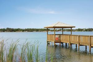 a wooden pier with a gazebo on the water at Tru By Hilton Sebring FL in Sebring