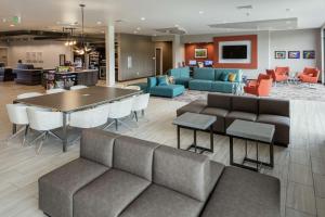 a lobby with a couch and a table and chairs at Hilton Garden Inn Wenatchee, Wa in Wenatchee