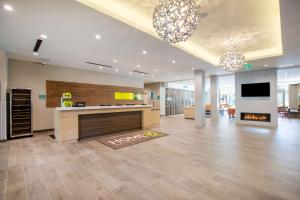 an office with a lobby with a fireplace and a tv at Home2 Suites By Hilton Carlsbad, Ca in Carlsbad