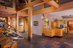 a lobby with stairs and a counter in a store at Chrysalis Inn & Spa Bellingham, Curio Collection by Hilton in Bellingham