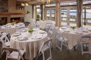 a banquet hall with tables and chairs and a fireplace at Chrysalis Inn & Spa Bellingham, Curio Collection by Hilton in Bellingham