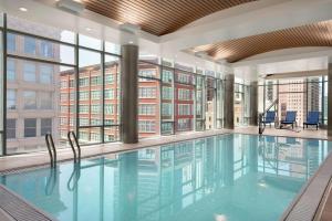 a large swimming pool in a building with windows at Homewood Suites By Hilton Chicago Downtown South Loop in Chicago