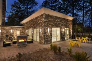 a stone house with a fireplace in front of it at Hampton Inn & Suites Ocean City West in Ocean City