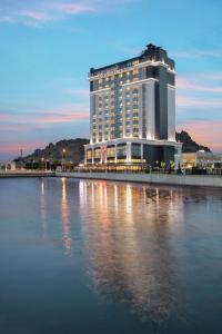 a large building sitting on the side of a body of water at Doubletree By Hilton Afyonkarahisar in Afyon