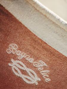a brown and white rug with the word welcome on it at Hotel La Pigna in Marina di Pietrasanta