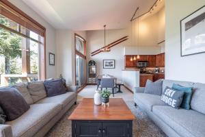 a living room with a couch and a table at Taluswood Bluffs by Outpost Whistler in Whistler