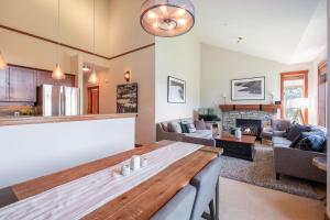 a kitchen and living room with a table and a couch at Taluswood Bluffs by Outpost Whistler in Whistler