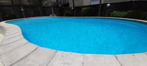 a large blue swimming pool in front of a building at Coco Lux Mon Amour in Grand Baie