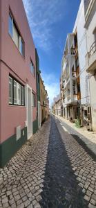 a cobblestone street in a city with buildings at RIVERINN QUARTOS No Centro Histórico De Portimão RC in Portimão