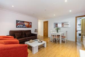 a living room with a couch and a table at BNBHolder Apartamentos en Sol Confort 6 in Madrid
