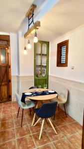 a dining room with a table and chairs at Casa rural Almazara in Letur +8 photos
