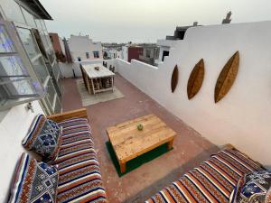a balcony with couches and a table on a building at Anir of sea tamraght in Agadir