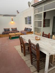 a living room with a wooden table and chairs at Anir of sea tamraght in Agadir