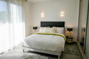 a bedroom with a large white bed with white pillows at Villa Luz 37 - Jacuzzi Terrace & Swimming Pool in Albufeira