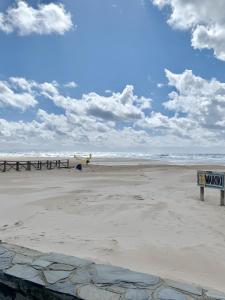 a view of a beach with a sign on it at Apartamento Tarifa Playa Lances in Tarifa +12 photos
