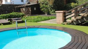 a large blue swimming pool in a yard at Casa Daniela en la Asomada in La Asomada