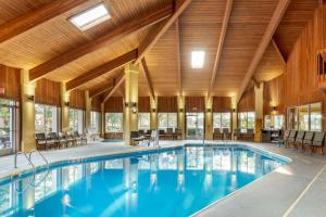 a swimming pool in a building with a wooden ceiling at Best Western Plus Wilmington/Carolina Beach in Wilmington