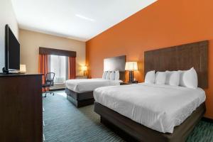 Rúm í herbergi á Best Western Plus Longhorn Inn & Suites