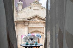 a view of a building from a window at La Finestra su Santa Lucia in Monopoli