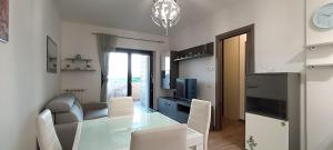 a dining room and living room with a glass table at HeavenHouse in Casale Smeraldi