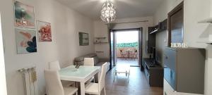 a kitchen and a living room with a table and chairs at HeavenHouse in Casale Smeraldi
