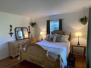 a bedroom with a large bed and a mirror at The Bourbon & Horse Country EpiCenter in Frankfort