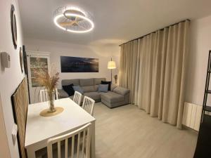 a living room with a couch and a table at APARTAMENTS L’ARC in Palafrugell