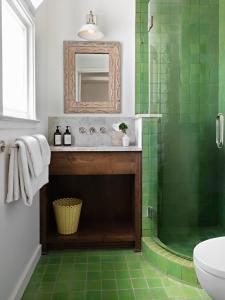 a bathroom with a sink and a shower with green tiles at Farmhouse Paso in Paso Robles