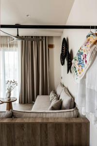 a bed in a room with butterflies on the wall at Lithos Luxury Villa in Archangelos