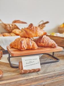 a bunch of croissants and other breads on a table at Farmhouse Paso in Paso Robles