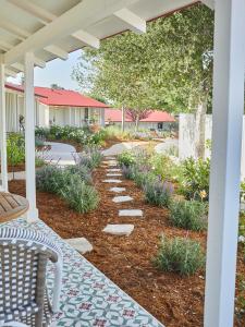 a patio with a stone walkway and a pergola at Farmhouse Paso in Paso Robles
