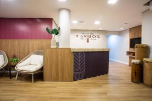 a waiting room with a tm morocco sign and chairs at Pousada Bahia Tambor in Morro de São Paulo