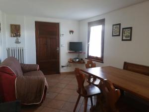 a living room with a wooden table and a couch at La Ville CIR00002 in Allein