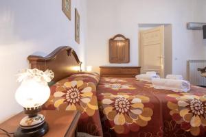 a bedroom with a bed and a lamp on a table at Casale Toscano [Piscina Wi-Fi] in Capannori