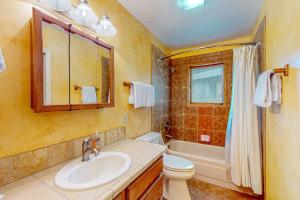 a bathroom with a sink and a toilet and a tub at Juniper Haven Retreat in Sun Valley +54 photos