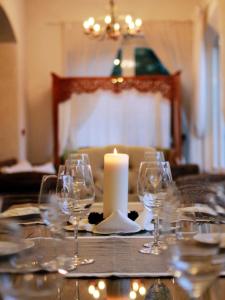 a table with wine glasses and a candle on it at Hotel La Pigna in Marina di Pietrasanta